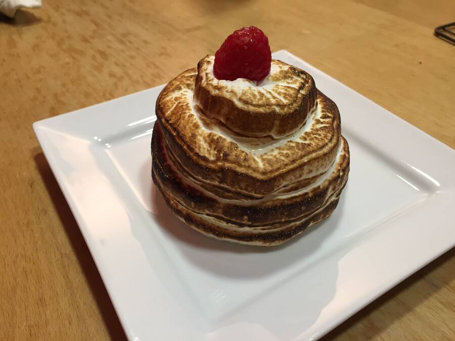 A stack of pancakes on a white plate.