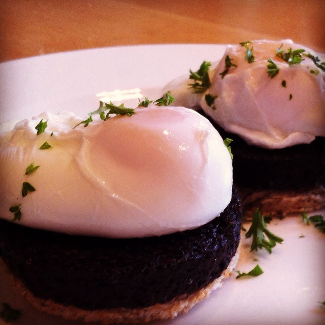 A plate with two poached eggs on toast, garnished with parsley.