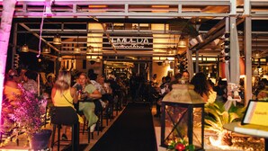 An outdoor dining area with a black carpet leading to a restaurant named "EMILEDA Seafood & Bar". - Apartel Park Osejava (Makarska)