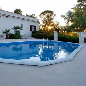 Een seizoensgebonden buitenzwembad en parasols bij het zwembad