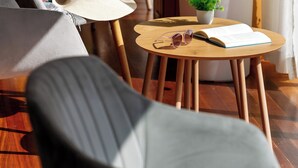 A cozy seating area with a sofa, a chair, and a small table with a plant and a book. - Hotel Don Manolito (Puerto de la Cruz)