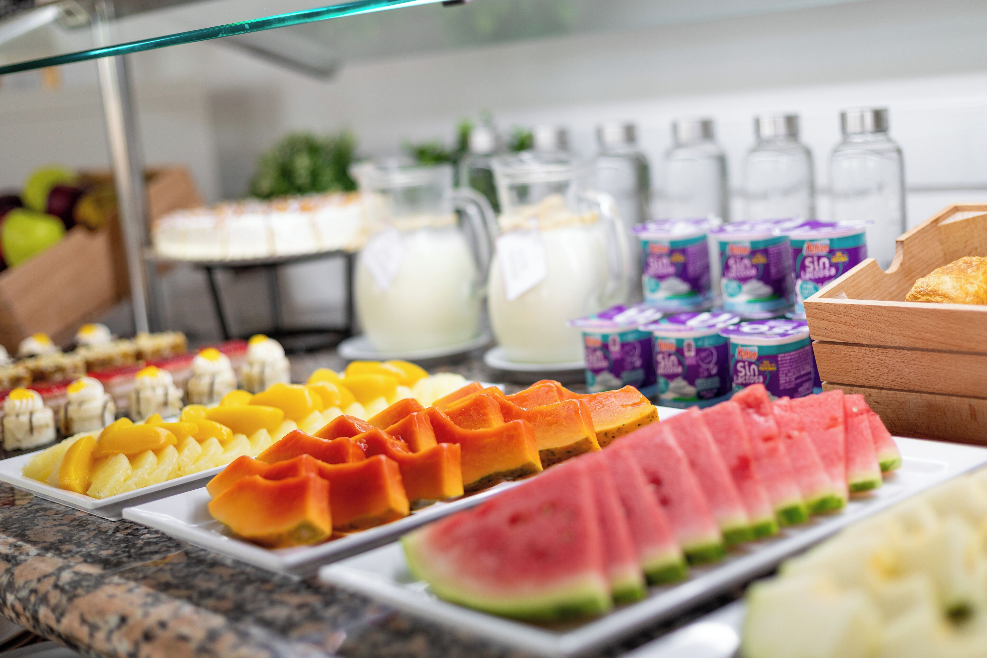 A buffet with various fruits and dairy products.