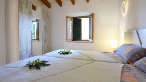 A bedroom with a bed, a window, a lamp, and a view of the outside. - Son Palanca, Finca 5starshome Mallorca (Sineu)