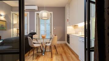 Deluxe Apartment, 1 Bedroom | Living area | 32-inch Smart TV with cable channels, TV, streaming services