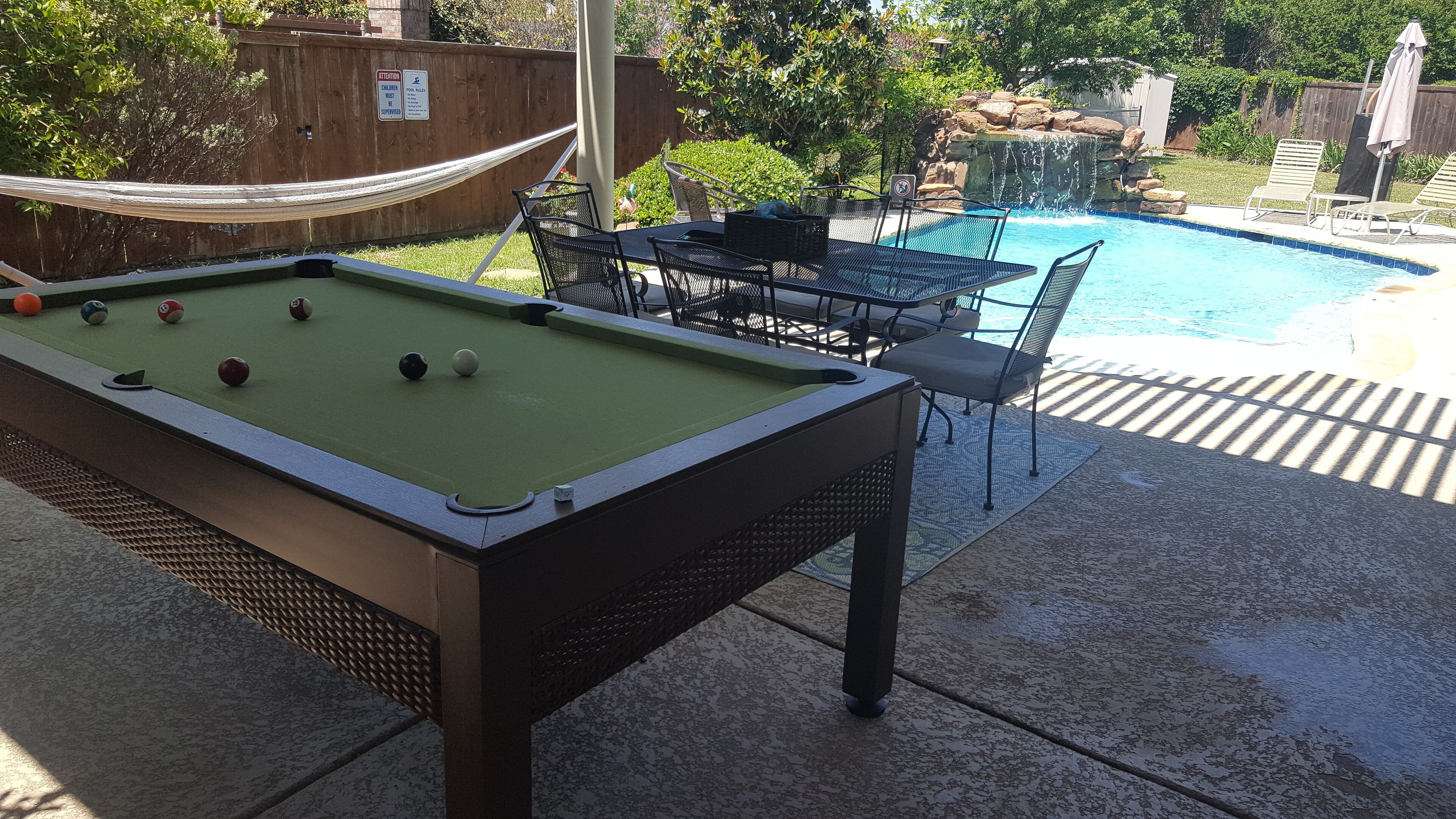 A pool table with billiard balls, a pool table, and a pool.