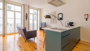A modern kitchen with a central island, a dining area with a bench, and large windows with a view.