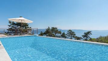 Outdoor pool, an infinity pool, sun loungers