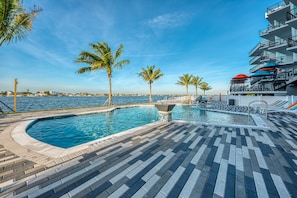 Outdoor pool, open 9:00 AM to 9:00 PM, pool umbrellas, pool loungers