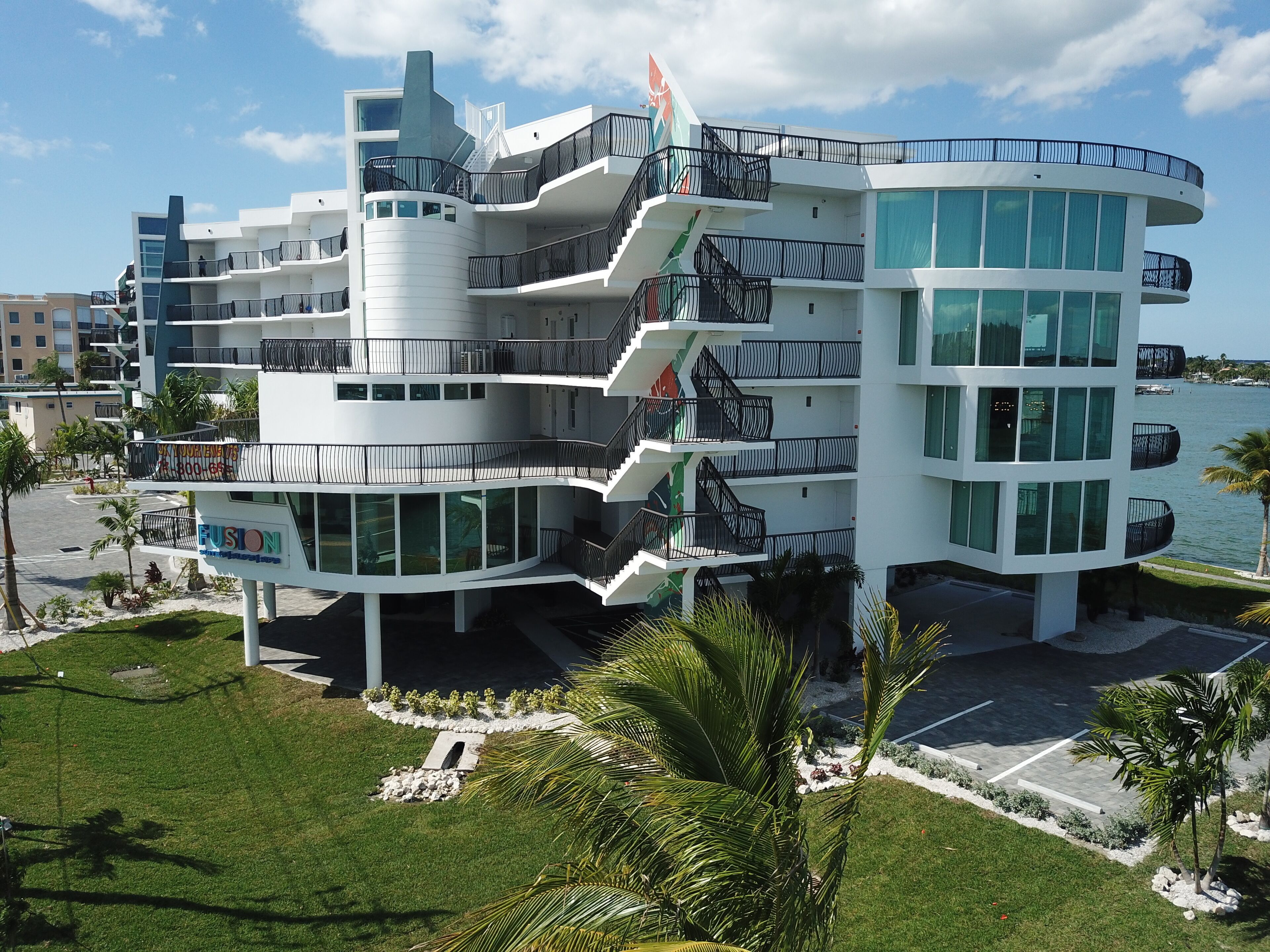 A multi-story hotel with a modern design, featuring balconies and large windows.