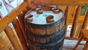 A wooden barrel with the Jack Daniel's logo, placed on a carpeted floor in a wooden-floored room. - Cozy Log Home, Centrally Located, 2 Master Suites, Hot Tub, Game and Movie Rooms (Sevierville)