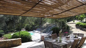 An outdoor patio with a pool, dining table, and chairs. - Character house, 'U STAZZU' (Ventiseri)