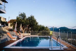 Relax by the pool with a stunning view of the surrounding landscape.