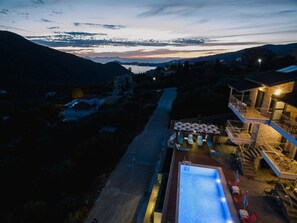 Relax by the resort's infinity pool, surrounded by a spacious deck with outdoor seating and breathtaking views of the surrounding landscape.