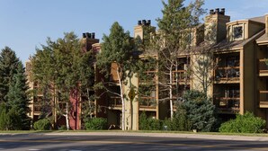 A multi-story hotel with a modern architectural design, featuring balconies and large windows.