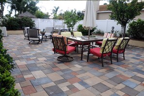 Enjoy dining al fresco on this patio with a dining set and comfortable seating.