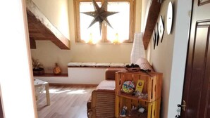 A cozy room with a wooden bench, a star decoration, and a window with curtains. - Superb Mansarda ... (Caserta)