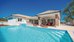 A two-story house with a swimming pool, outdoor seating, and a patio area. - Gorgeous home in Radosinovci with sauna (Radosinovci)