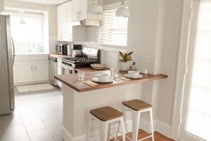 Enjoy casual dining and cooking in this kitchen with a central island, stainless steel appliances, and a gas stove.