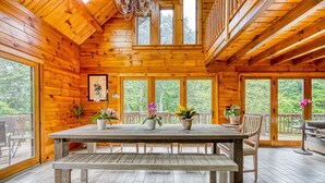 A wooden cabin with a large dining table, benches, and potted plants. - Luxurious & Enchanting Log House in Heart of Hudson Valley/Catskills, Upstate NY (Saugerties)