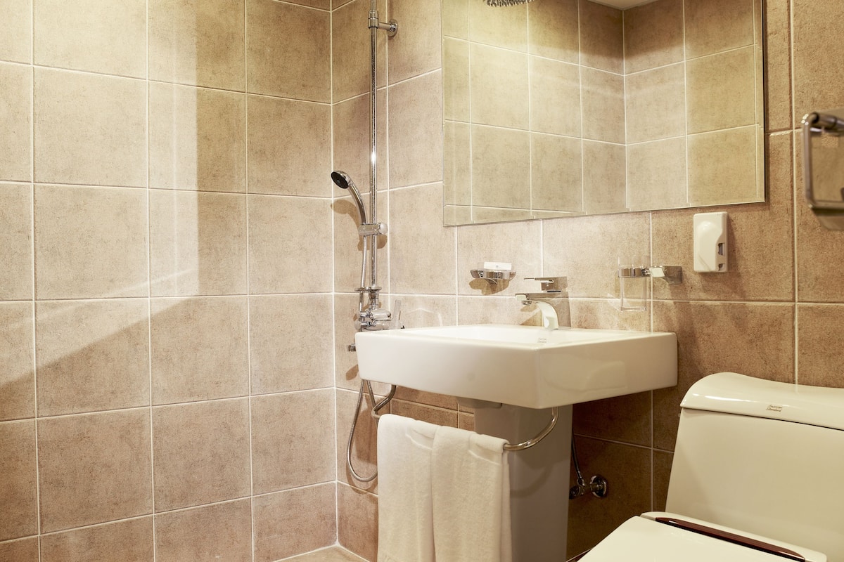 shower, hair dryer, slippers, towels