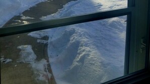A view through a window with snow-covered ground, trees, and a distant mountain range. - Gowdy Apartment. Fenced yard pet friendly , modern, clean. Gowdy Properties (Lake City)