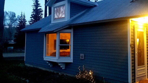 A two-story house with a visible window and a door. - Gowdy Apartment. Fenced yard pet friendly , modern, clean. Gowdy Properties (Lake City)