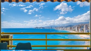 A view from a balcony with a railing, overlooking a beach and a cityscape. - Don Miguel 1 18-A (Benidorm)