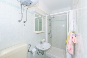 A bathroom with a sink, mirror, shower, and towel rack. - Beautiful Rustical Apartment in Rovinj (Rovinj)