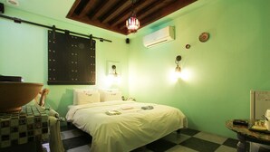 A room with a bed, a table with a bowl, and a checkered floor. - Hotel Yaja Uijeongbu Station (Uijeongbu)