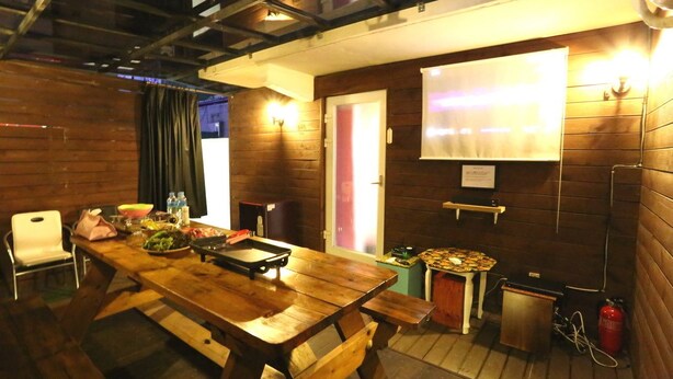 A wooden interior with a large table, chairs, and a fire extinguisher. - Hotel Yaja Uijeongbu Station (Uijeongbu)