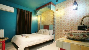 A room with a bed, a red chair, a white sink, and a patterned wall. - Hotel Yaja Uijeongbu Station (Uijeongbu)
