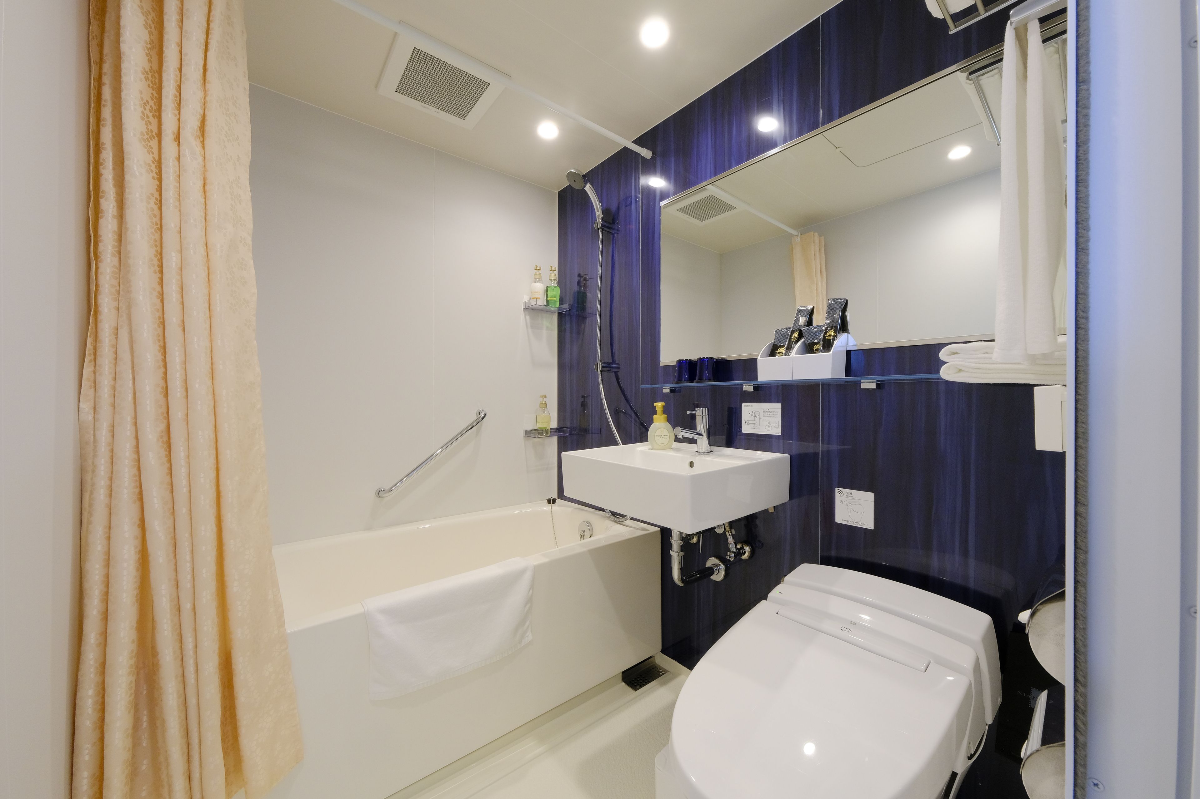 deluxe twin room | bathroom | free toiletries, slippers, bidet, towels