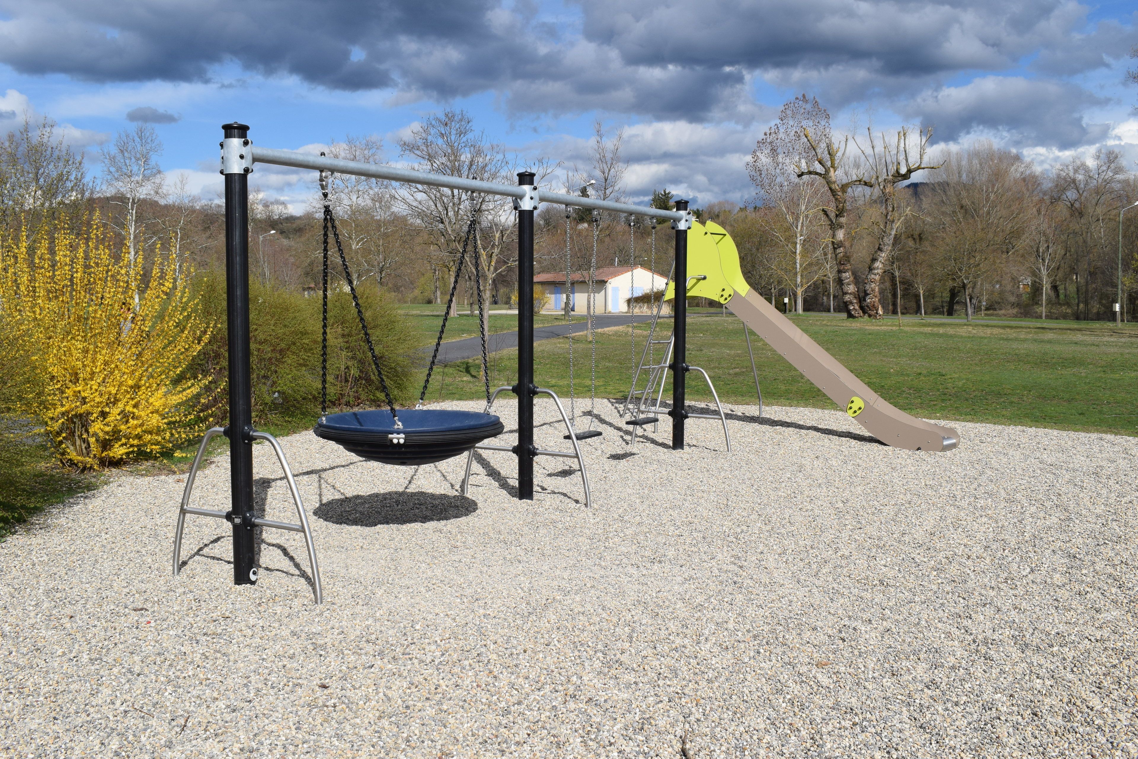 A playground with swings, a slide, and a climbing structure.