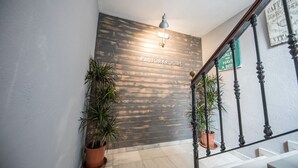A staircase with a wooden wall labeled "FACTORYROOMS" and a sign above it. - Factory Rooms Tarifa - Hostel (Tarifa)