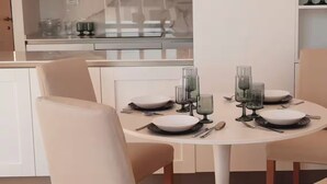 A dining area with a round table set for four, surrounded by beige chairs. - Penthouse with Rome View, Balconies, Two Bathrooms & Metro (Roma)