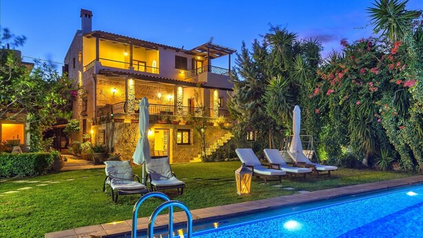 A two-story house with a swimming pool, outdoor seating, and a well-lit garden. - Villa Arhontariki stunning view, pool, BBQ close to Kissamos, Chania (KISSAMOS)