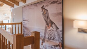 A large framed artwork of a person in a snowy landscape on a wall.
