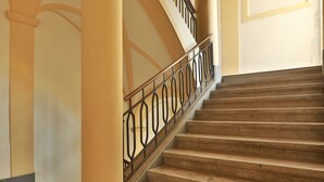 A staircase with a wooden handrail and a metal balustrade. - Amazing Sea View in Historic Building in Downtown by Wonderful Italy (Palermo)