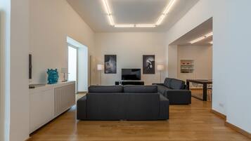 Deluxe Apartment | Living area | 30-inch TV with digital channels