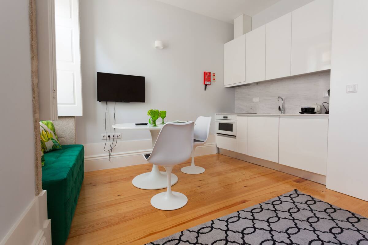 A modern kitchen with white cabinets, a built-in oven, and a countertop.