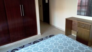 A bedroom with a bed, a wardrobe, and a dresser. - Atlantic Ocean Residence 3038 (Asilah)