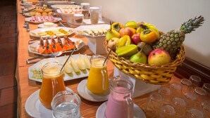 A buffet table with various food items and beverages.