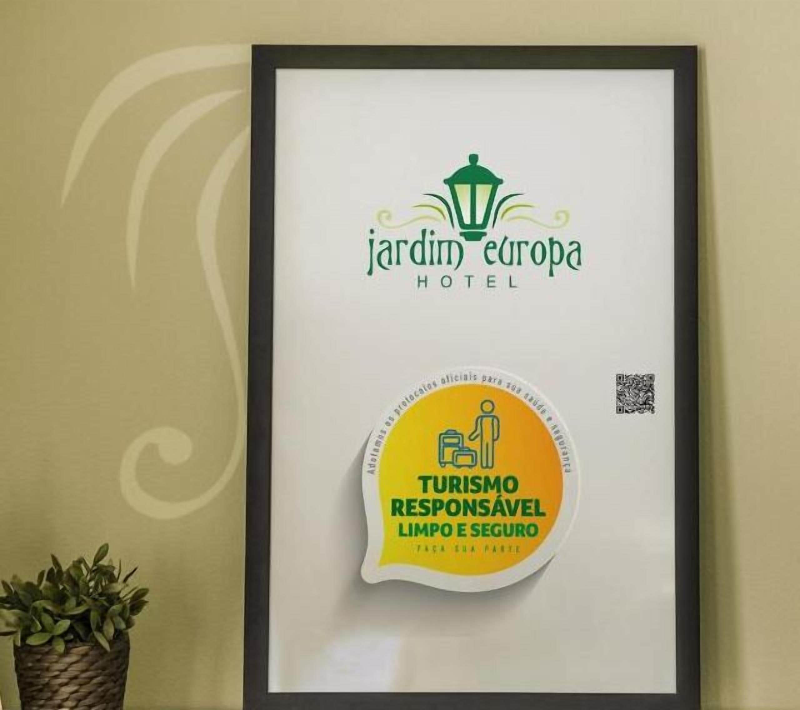 A framed sign for Jardin Europa Hotel with a logo and a QR code.