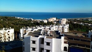 A coastal cityscape with white buildings, a clear blue sky, and the sea in the background. - Bella Vista Cabo 3455 Residence (Cabo Negro)