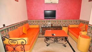 A living room with a sofa set, a coffee table, and a TV mounted on the wall. - ����������������������������������������������������������������������������������������������������������������������������������������������������������������������������������������� (Marrakech)