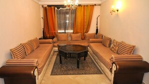 A living room with a sofa set, a coffee table, and a chandelier. - ����������������������������������������������������������������������������������������������������������������������������������������������������������������������������������������� (Marrakech)