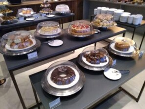 A buffet with various desserts displayed in clear glass covers. - Dall'Onder Ski Hotel (Garibaldi)