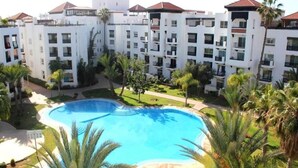 A hotel with multiple white buildings, a swimming pool, and palm trees. - Residence Marina Agadir 2952 (Agadir)