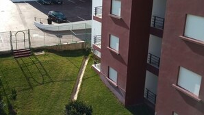 A multi-story residential building with a parking area in front. - Atlantic Ocean Residence 3033 (Asilah)