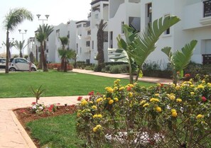 Residents enjoy a serene atmosphere with beautifully maintained gardens and balconies.